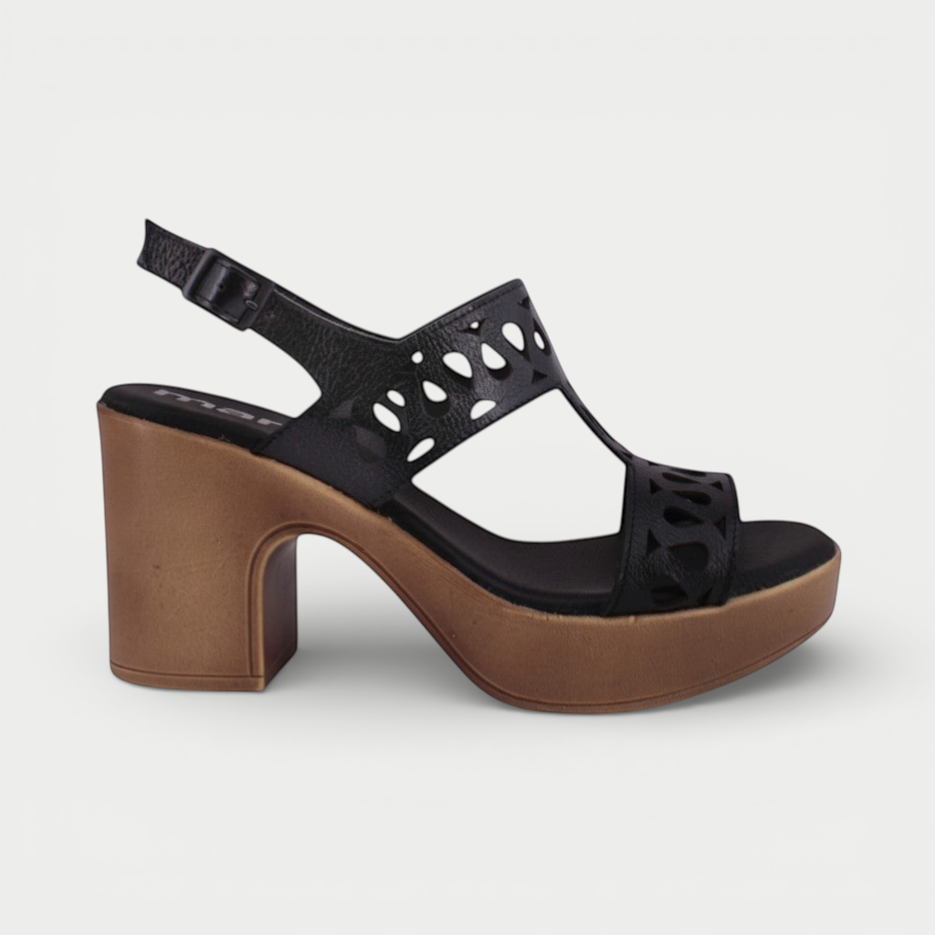 Manet black leather sandals with cut-out details and a chunky wooden-effect heel. Adjustable ankle strap for comfort.