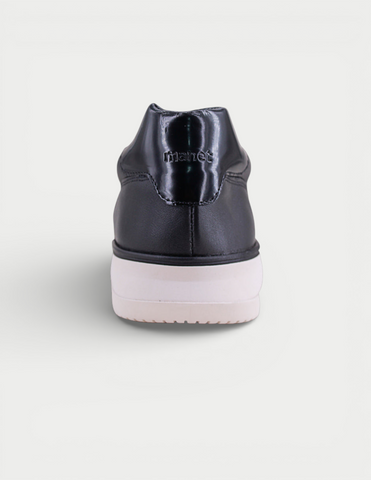 Manet Midas 01 black leather sneakers with white sole and shiny heel detail.