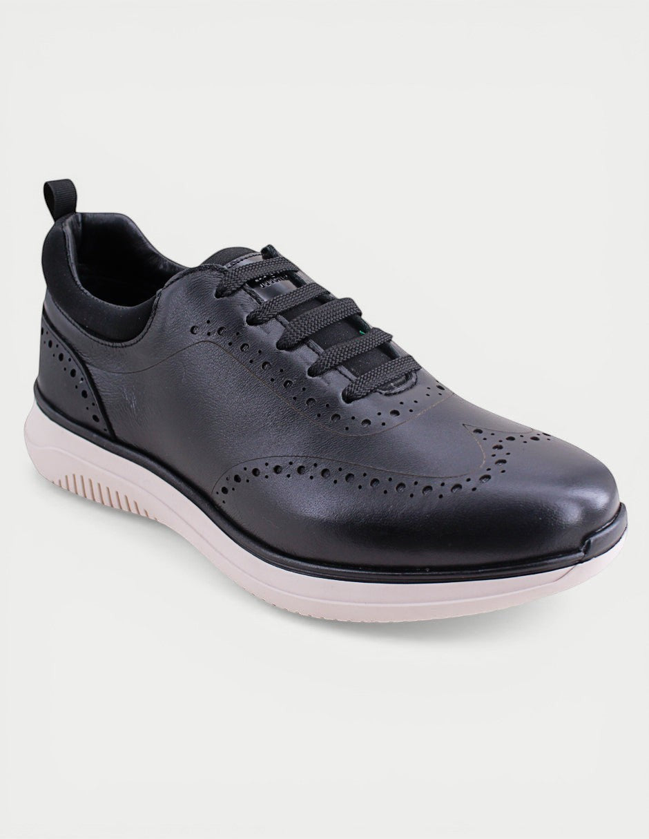 Manet Midas 02 black leather wingtip sneakers with white sole and brogue detailing.
