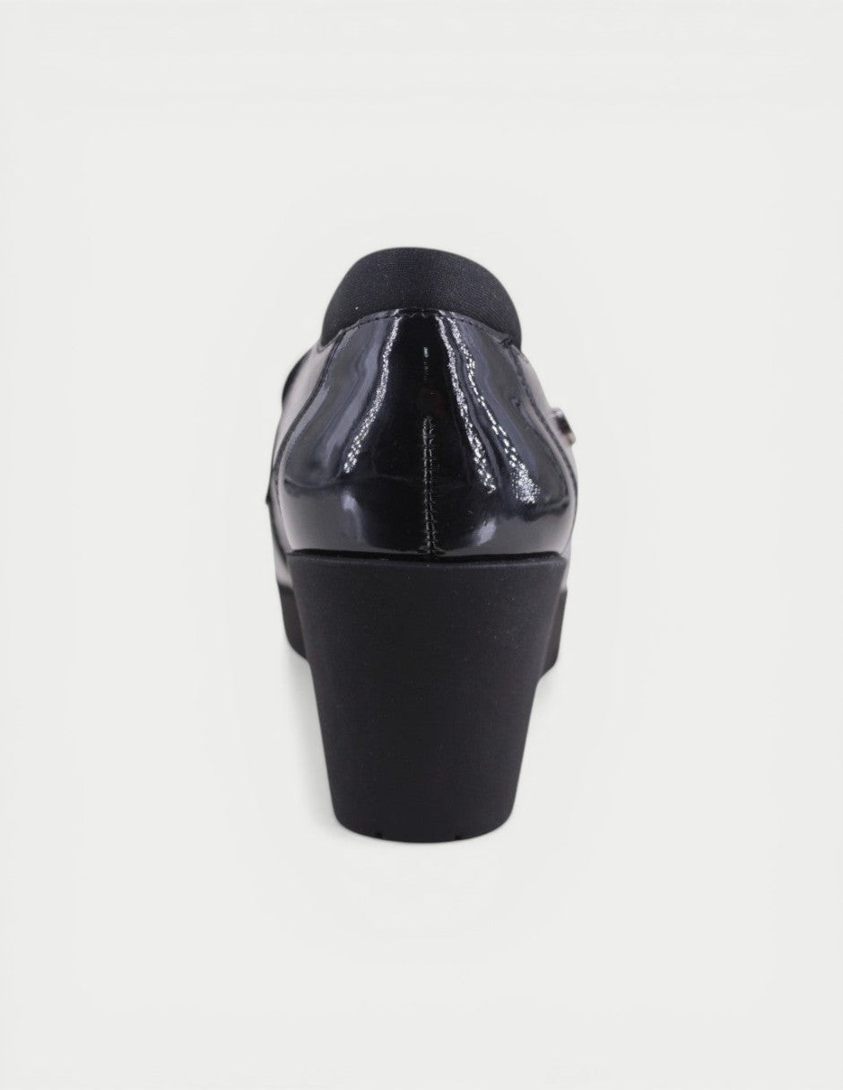 Manet black patent leather women's moccasin with a comfortable wedge heel and modern design.