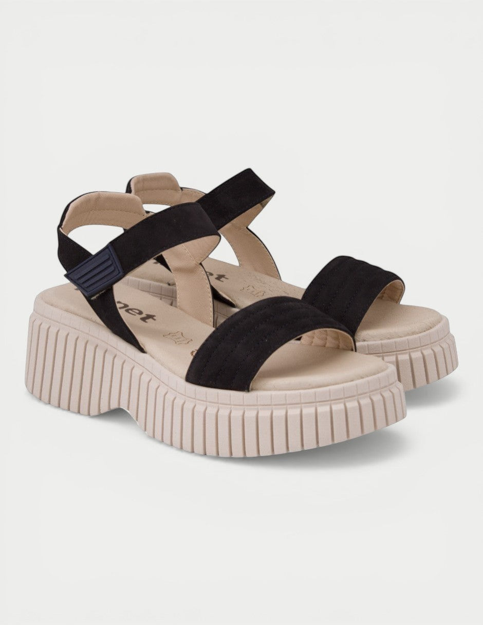 Manet black suede chunky platform sandals with adjustable ankle strap and beige sole.